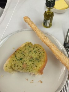 Garlic bread (half eaten) and bread stick
